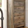 Signature Design By Ashley Trinell Rustic 5 Drawer Chest Of Drawers With Nailhead Trim, Warm Brown